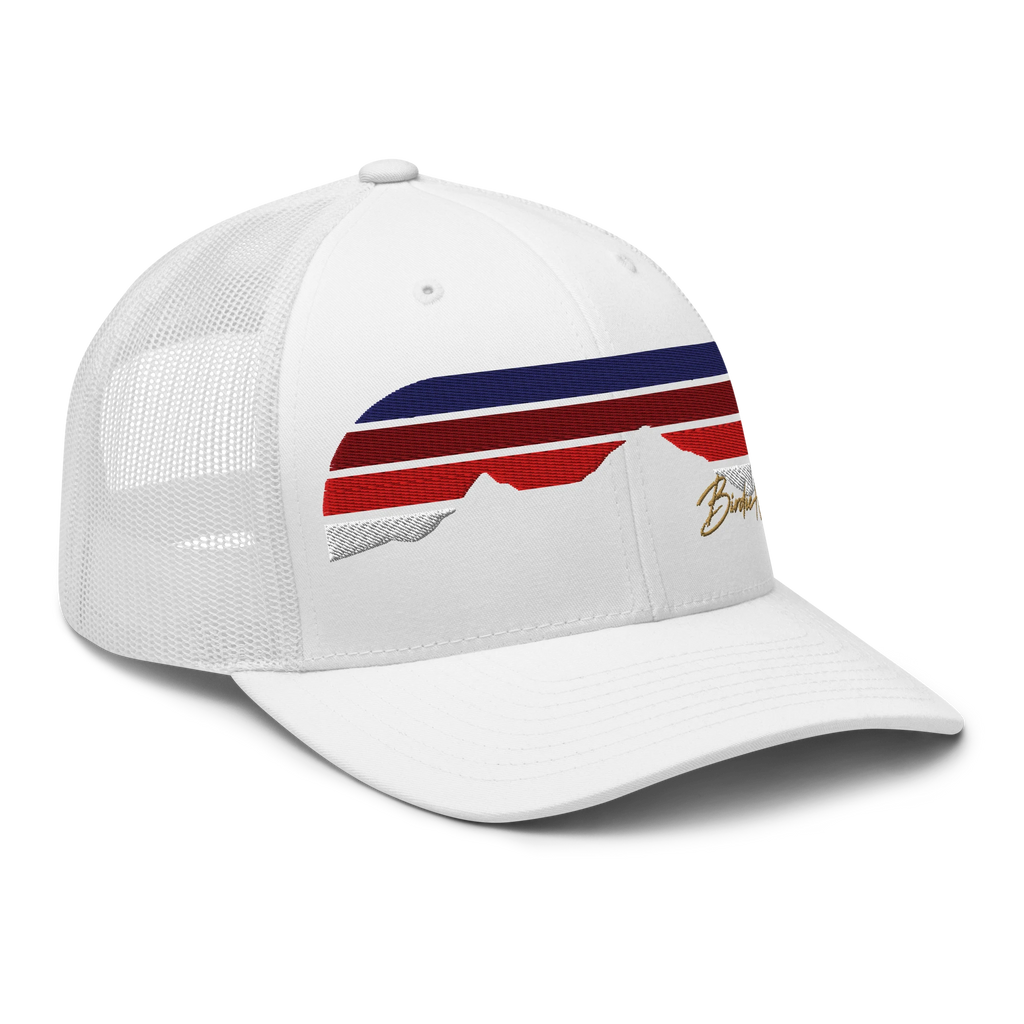 Birdie National white six-panel trucker cap with mesh back, red and blue striped mountain graphic, and gold embroidery.